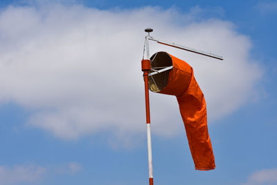 Low angle view of flags hanging against sky