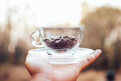 Close-up of hand holding coffee cup