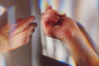 Close-up of hand by wall