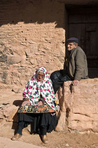 Woman sitting with umbrella