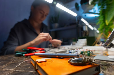 Midsection of man working on table