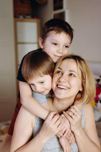 Happy caucasian woman with children at home