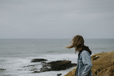 Man looking at sea against sky