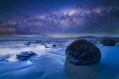 Scenic view of sea against sky at night