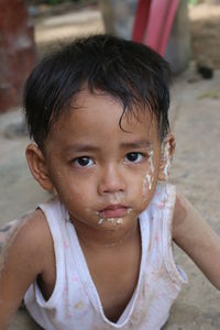 Close-up portrait of cute boy with messy face