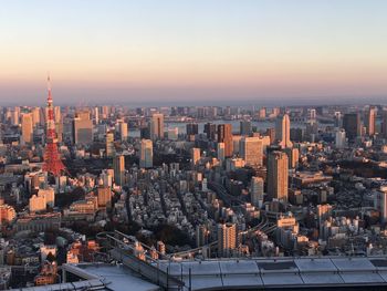 Aerial view of buildings in city during sunset