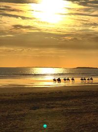 Scenic view of beach against sky during sunset