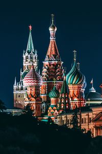 Illuminated temple against clear sky at night