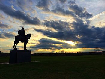 Silhouette of landscape against dramatic sky