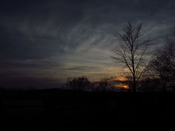 Silhouette of trees against sky at sunset