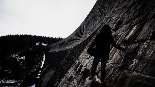 Full length of woman standing on mountain against sky