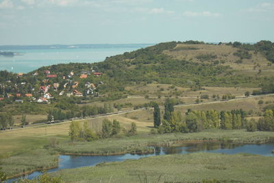 Scenic view of sea and trees against sky