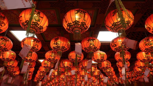 Low angle view of illuminated lanterns hanging from ceiling