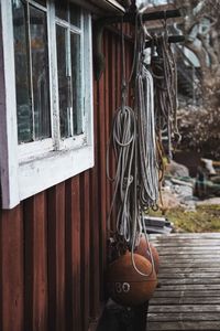 Buoy hanging with rope outside of wooden cabin