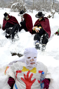 People on snow covered landscape during winter