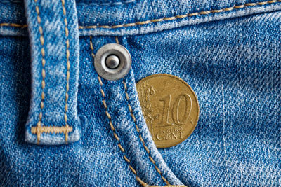 Close-up of coin in jeans pocket