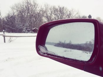 Close-up of cropped car on snow covered landscape