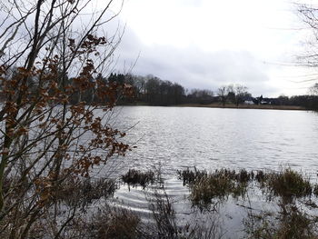 Scenic view of lake against sky during winter