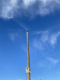 Low angle view of communications tower against sky