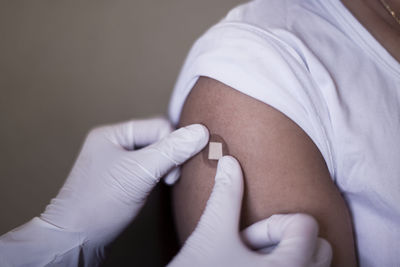 Putting band-aid onto arm after vaccination