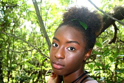 Close-up portrait of young woman in forest