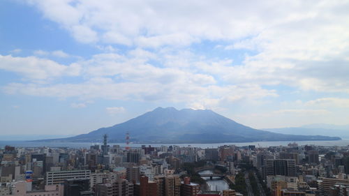 Cityscape against cloudy sky