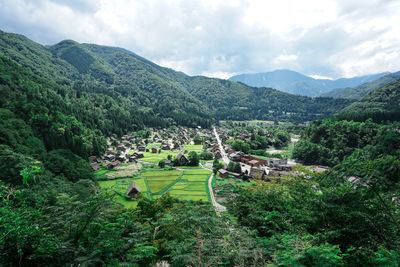 High angle view of trees and buildings against sky