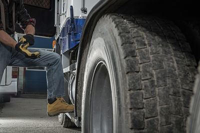 Low section of man standing by truck