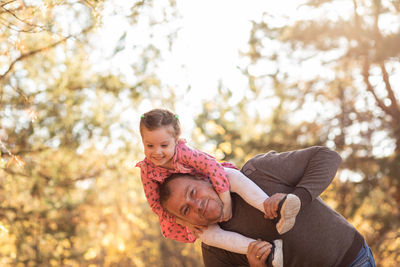 Father and child having fun playing. young dad and daughter spending time together in nature