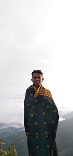 Side view of man standing against sky