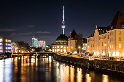 Canal passing through city buildings at night