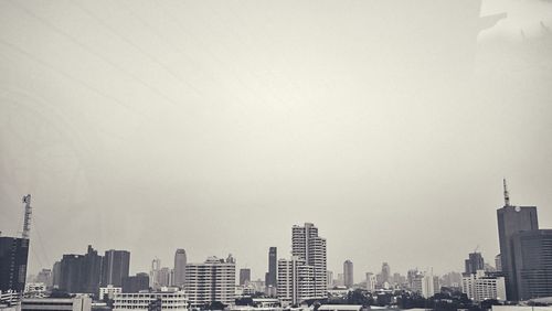 Buildings in city against clear sky