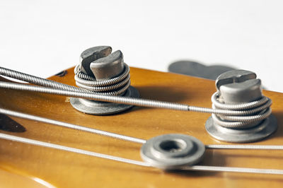 Close-up of guitar on table against white background