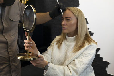 Portrait of young woman wearing sunglasses against sky