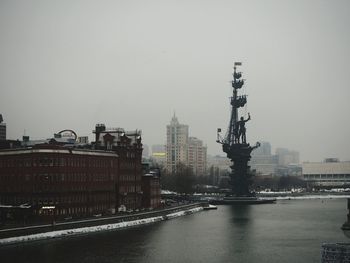 Buildings in city against clear sky