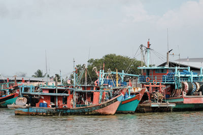 Boats moored at sea against clear sky