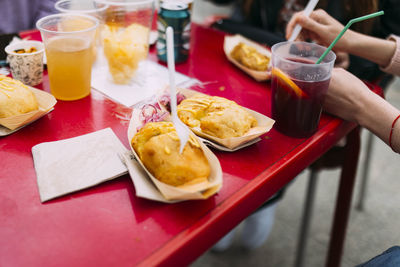 Chips, cocktails with wine, beers, stuffed potatoes with onion and sauce. street food.