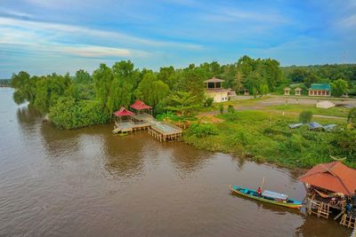 Scenic view of river by trees against sky