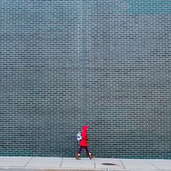 Side view of man running on footpath