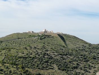 Low angle view of castle on mountain against sky