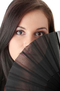 Close-up portrait of young woman covering face