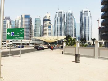 View of city street and buildings against sky