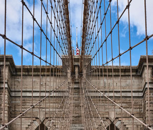 Low angle view of suspension bridge against sky