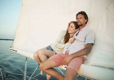 Couple relaxing while traveling in yacht