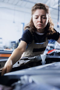 Portrait of young woman sitting in car