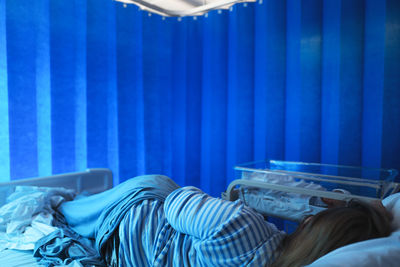 Close-up of woman lying on bed at hospital