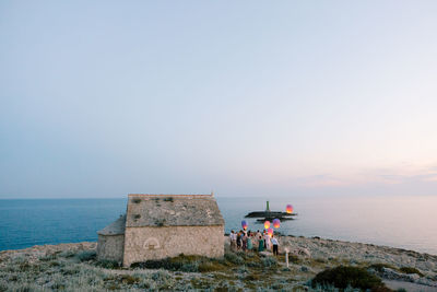People on beach against sky