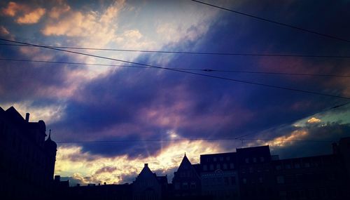 Low angle view of buildings against cloudy sky