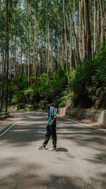 Rear view of woman walking in forest