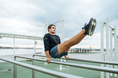 Low angle view of man exercising in gym